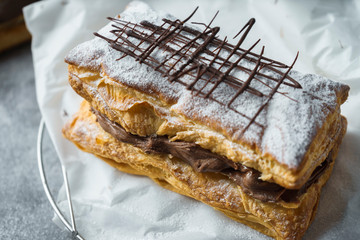Puff pastry with confectioner's sugar and chocolate filling