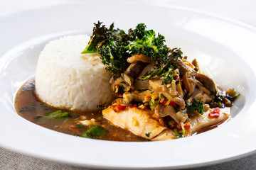 Cod with shiitake mushrooms and rice in asian spicy broth