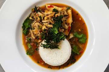 Cod with shiitake mushrooms and rice in asian spicy broth