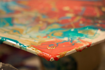 Red and blue paint on canvas. Extreme close up.