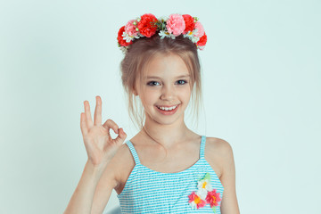 Cute girl showing ok sign with hand looking happily to the camera