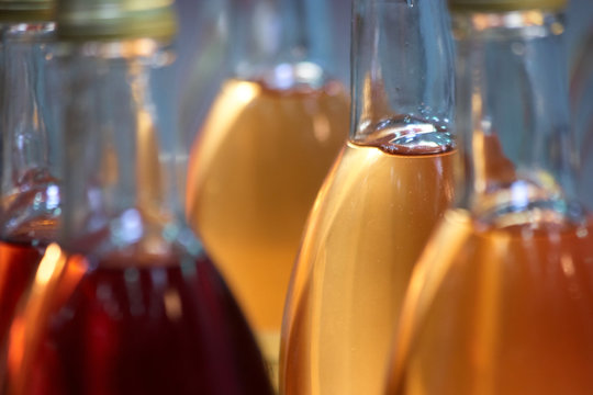 Extreme close up bottles with colored liquid. Sweet or alcoholic drinks.
