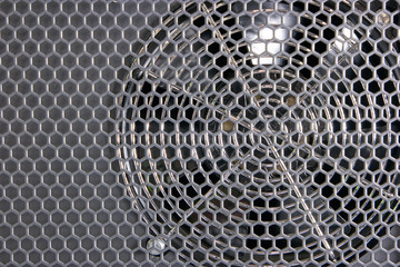 Close up cooler fan for computer. Grey grid.
