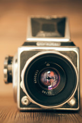 vintage camera on a wood background..