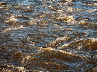 Quick water flow in a river, Nature background. Selective focus.