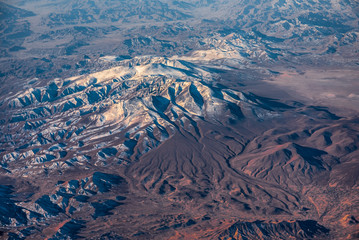 Aerial View from an Airplane. Flying above Beautiful Land at Sunrise.