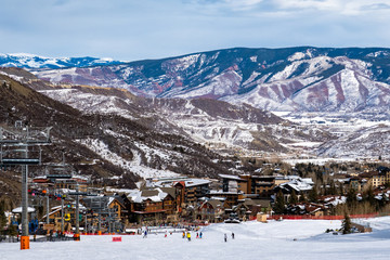 Panoramic view of Snowmass Village, with skiers skiing at the Aspen Snowmass ski resort in the...