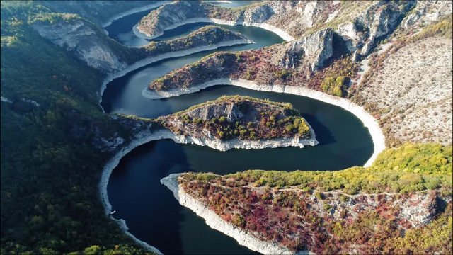 Breathtaking aerial view of zigzag Uvac river under Golija mountain and Pester plateau on bright sunny day. Serbia.