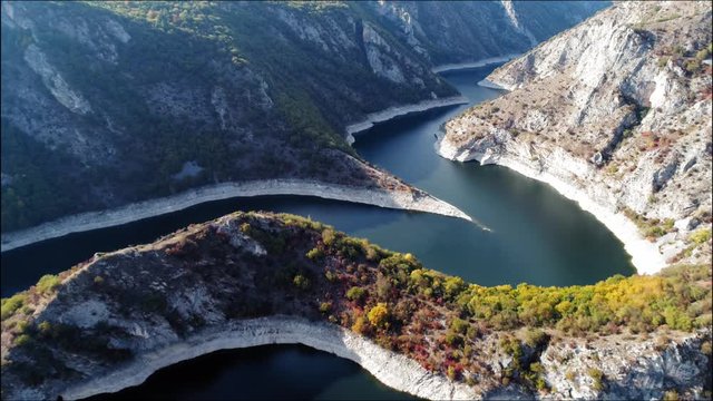 Drone flying over curvaceous Uvac river under Golija mountains and Pester plateau. Serbia. Aerial.