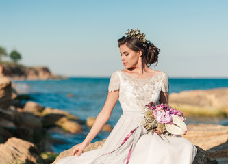 Fototapeta na wymiar Young beauty fashion bride with bouquet of flowers in her hands.