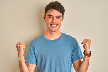 Teenager boy wearing casual t-shirt standing over isolated background celebrating surprised and...