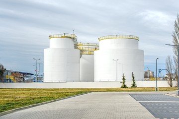 Group of large steel storage tanks at refinery 