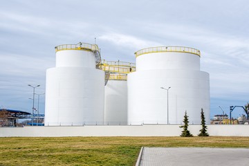 Group of large steel storage tanks at refinery 