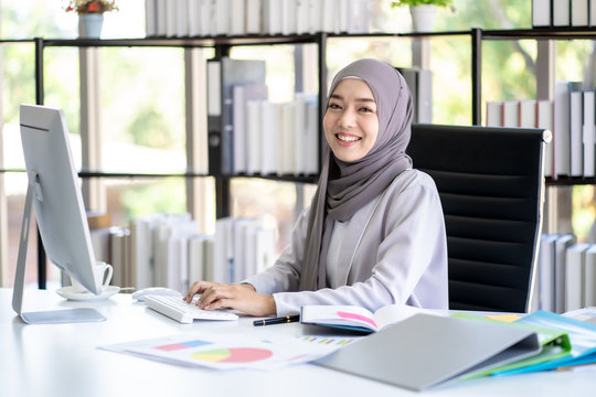 Muslim Business Woman in Hijab with Documents at Workplace in Office.