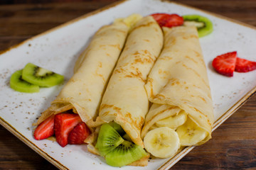Healthy crepes with fruits, banana, kiwi and strawberry. Healthy french breakfast