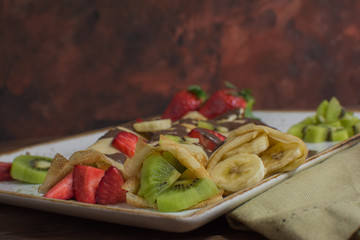 Healthy crepes with fruits, banana, kiwi and strawberry. Healthy french breakfast