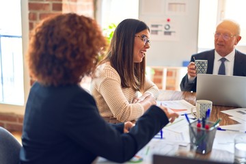 Group of business workers smiling happy and confident. Speaking with smile on face working together at the office.