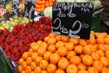 Fresh fruits with prices in german at the famous weekly market "Naschmarkt" in Vienna, Austria 