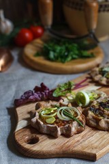 open pies made of buckwheat flour with cabbage filling, decorated with leeks, close-up