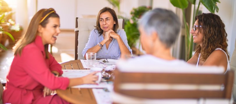 Young beautiful girl smiling happy and confident sitting dinking cup of coffee at terrace