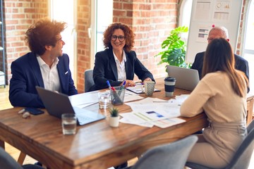 Group of business workers smiling happy and confident. Speaking with smile on face working together at the office.
