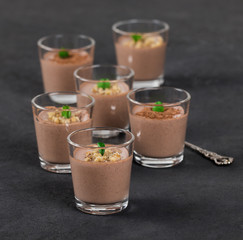 Italian dessert Panna cotta chocolate nut in a glass on a dark background