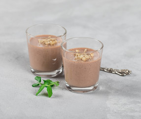 Italian dessert Panna cotta chocolate nut in a glass on a light background