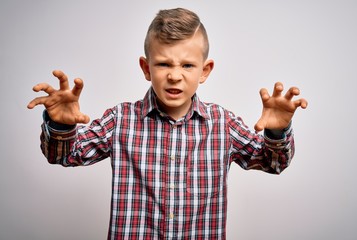 Young little caucasian kid with blue eyes wearing elegant shirt standing over isolated background...