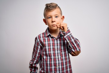 Young little caucasian kid with blue eyes wearing elegant shirt standing over isolated background...