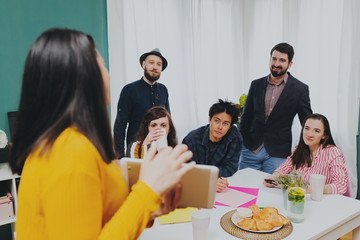 Creative Director Discusses New Idea With Colleagues For Advertising Campaign. Team of young creative businessmen having a live debate on a promising progect. Teamwork and brainstorming concept.