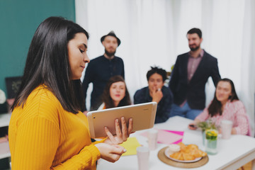 Business Woman Team Leader Sharing Ideas In Office Training Presentation Seminar.Yong business woman presenting new leadership ideas at meeting with colleagues in modern office.