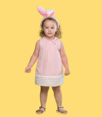 Lovely blonde toddler wearing easter bunny ears