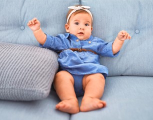 Fototapeta premium Adorable baby lying down on the sofa at home. Newborn relaxing and resting comfortable