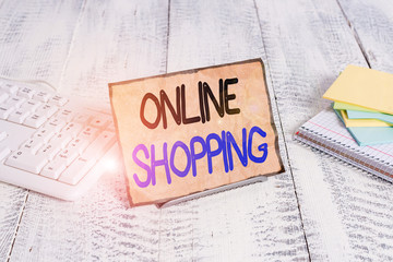 Text sign showing Online Shopping. Business photo text consumers directly buy goods from a seller over the Internet Notepaper stand on buffer wire in between computer keyboard and math sheets