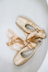 Pointe shoes in beige on a white background. Shoes for the ballerina.