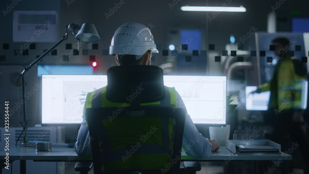 Poster Industrial Engineer Solving Problems, Working on a Personal Computer, Two Monitor Screens Show CAD Software with 3D Prototype of Eco-Friendly Electric Engine Concept. Back View Zoom Out