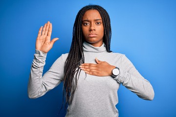 Young african american woman standing wearing casual turtleneck over blue isolated background...