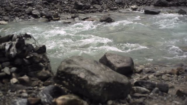 Rocky water rapids river, medium shot, shallow DOF
