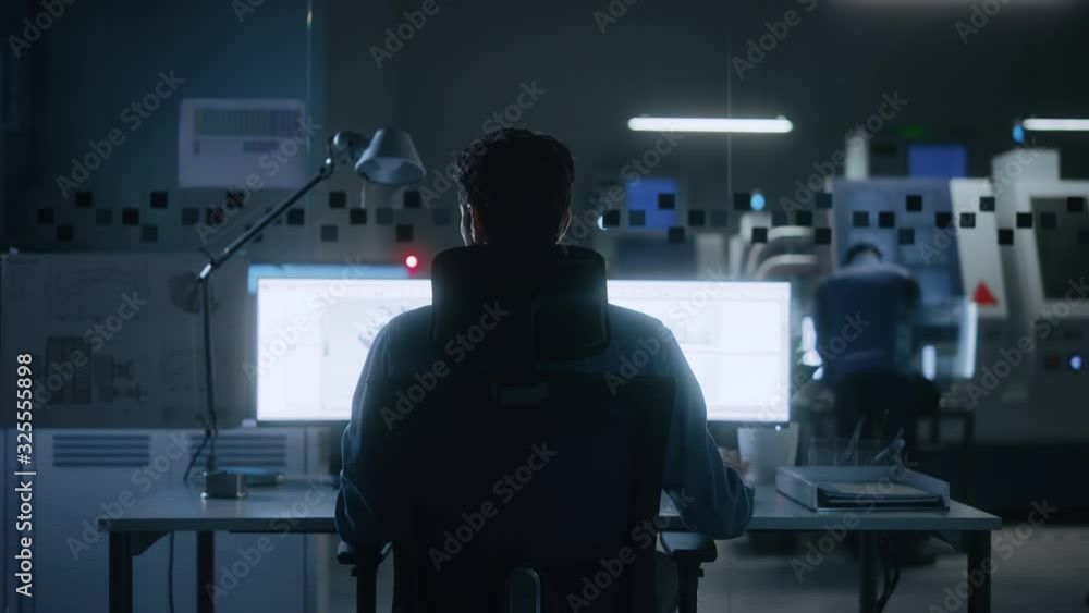 Leinwandbilder Industrial Engineer Solving Problems, Working on a Personal Computer, Two Monitor Screens Show CAD Software with 3D Prototype of Eco-Friendly Electric Engine Concept. Back View Zoom in