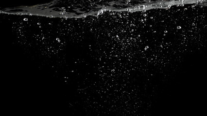 Bubbles underwater splashing and floating up and black color background which represent carbonate...