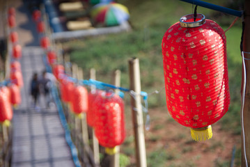 Perspective red lantern on a wooden path way