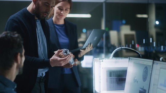 Industry 4.0 Modern Factory: Team of Innovative Industrial Engineers Use Computer and 3D Printer to Build Complex Component. Group of Scientists Use High-Tech Machinery for Futuristic Design