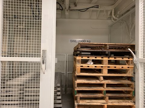 Wooden pallets inside service lift.