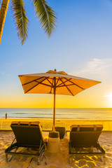 Beautiful tropical nature umbrella chair with palm tree around beach sea ocean at sunset or sunrise