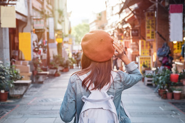 Young woman traveler walking in the shopping street, Travel lifestyle concept