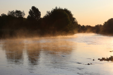 Obraz na płótnie Canvas Golden mist rises off the Conestogo River, just outside St. Jacobs, Ontario, Canada.