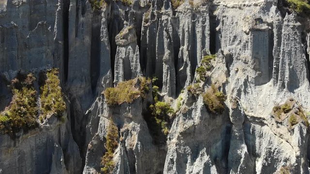 A rising Aerial view of Putangirua Pinnacles rock formations in New Zealand