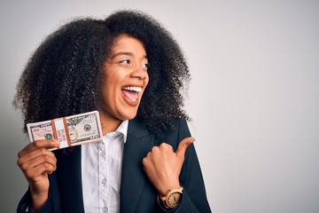 Young african american business woman with afro hair holding a bunch of cash dollars banknotes...