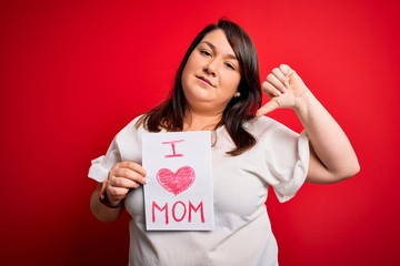 Beautiful brunette plus size woman holding love mom message celebrating mothers day with angry...