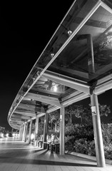 Empty modern pedestrian walkway in park at night